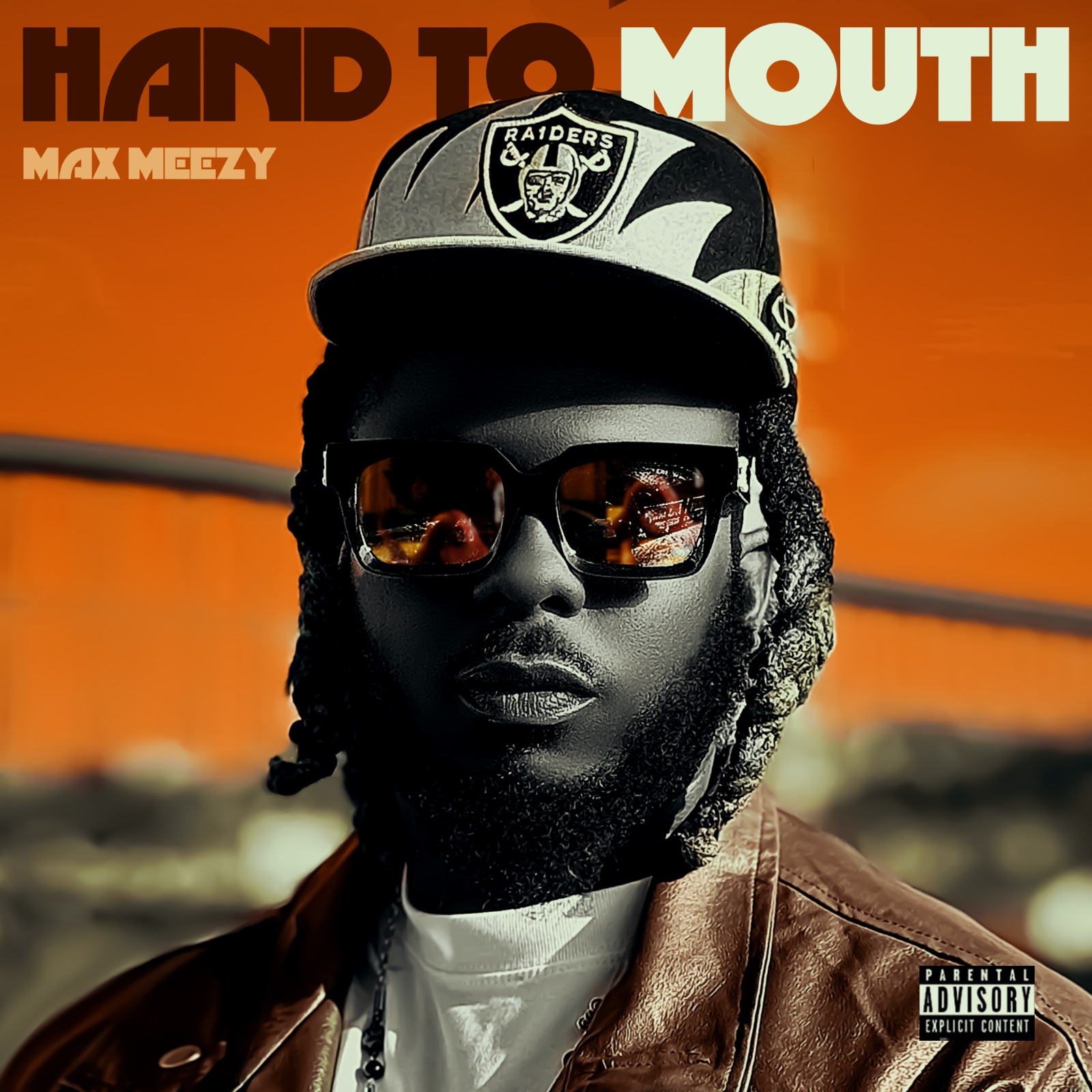 Hand to Mouth single artwork: Max Meezy in a Raiders cap, dark sunglasses and a brown leather jacket against a deep orange sky, with HAND TO MOUTH in block lettering and a parental advisory label