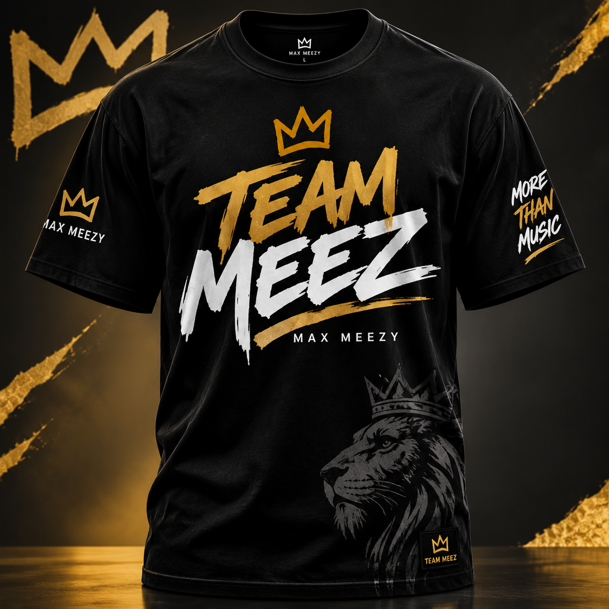 Max Meezy Team Meez tee: black t-shirt seen from the front, gold crown outline above TEAM in gold brush lettering and MEEZ in white, MAX MEEZY beneath, a crowned lion head at the lower hem and gold crown sleeve tags